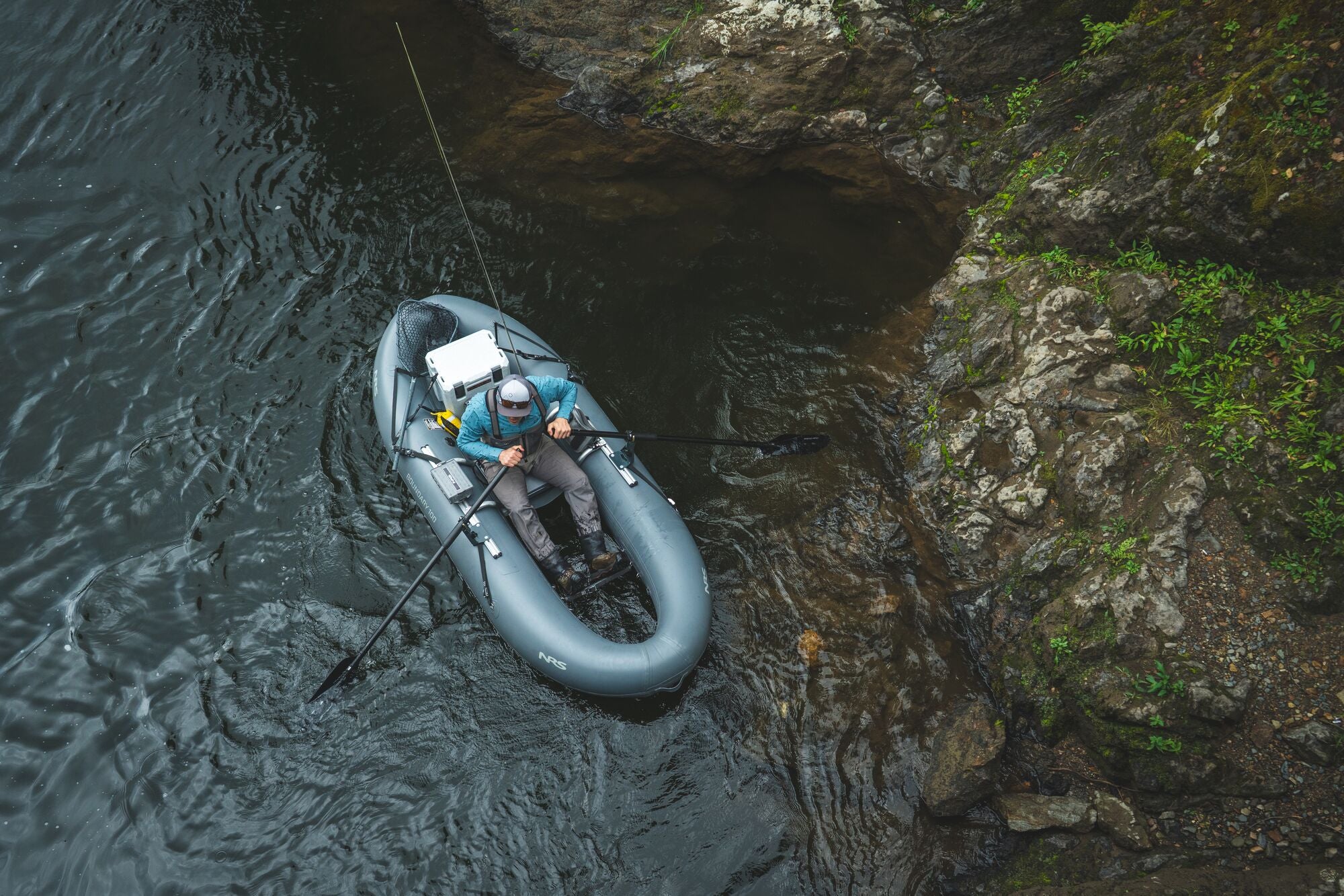Person on raft in river fishing