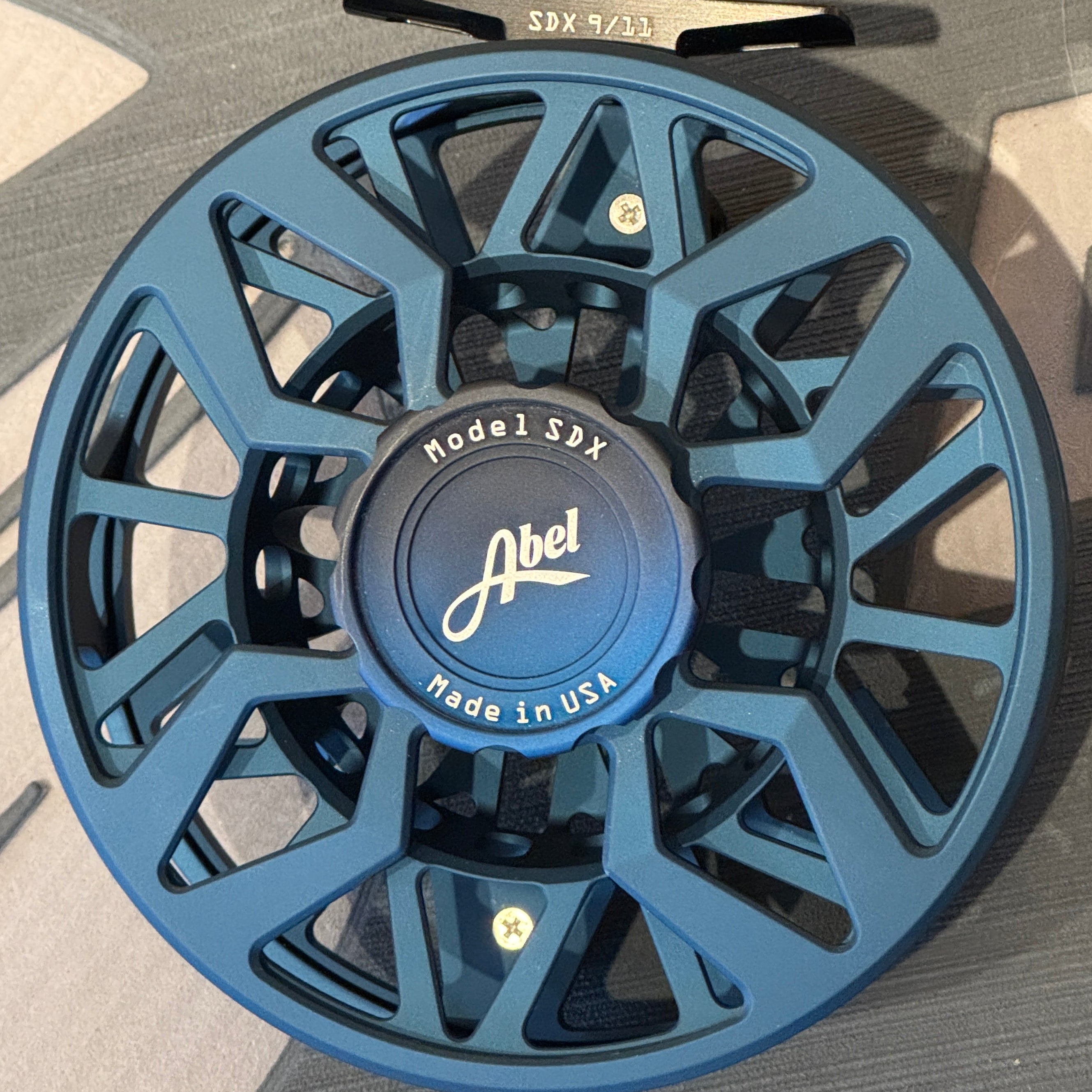 Blue fishing reel on a gray background