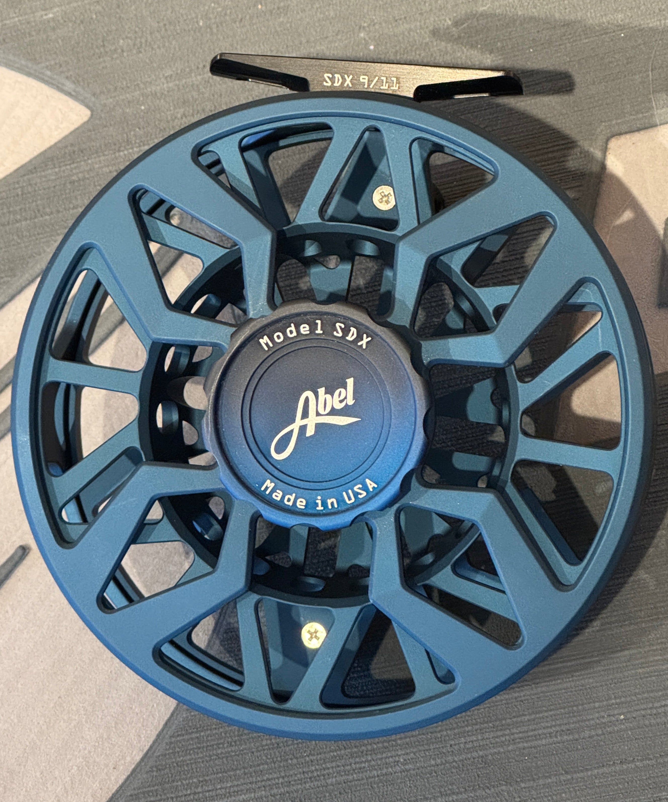 Blue fishing reel on a gray background