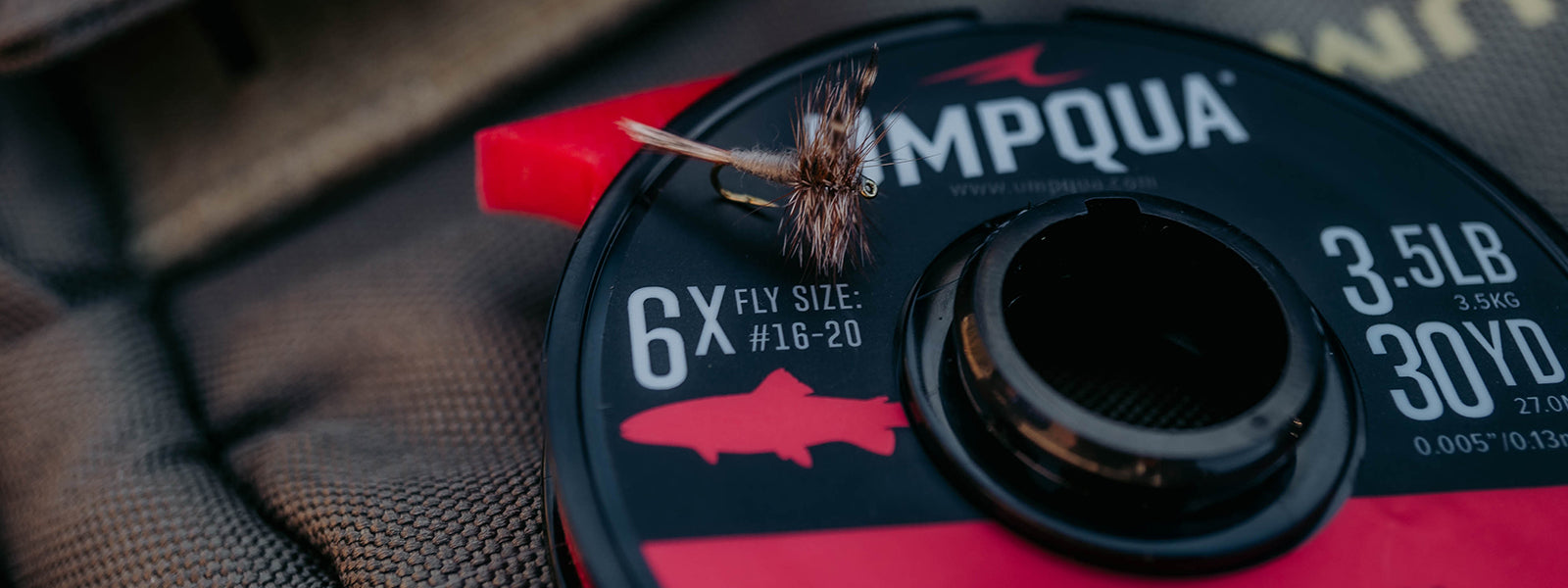 adams dry fly on tippet spool