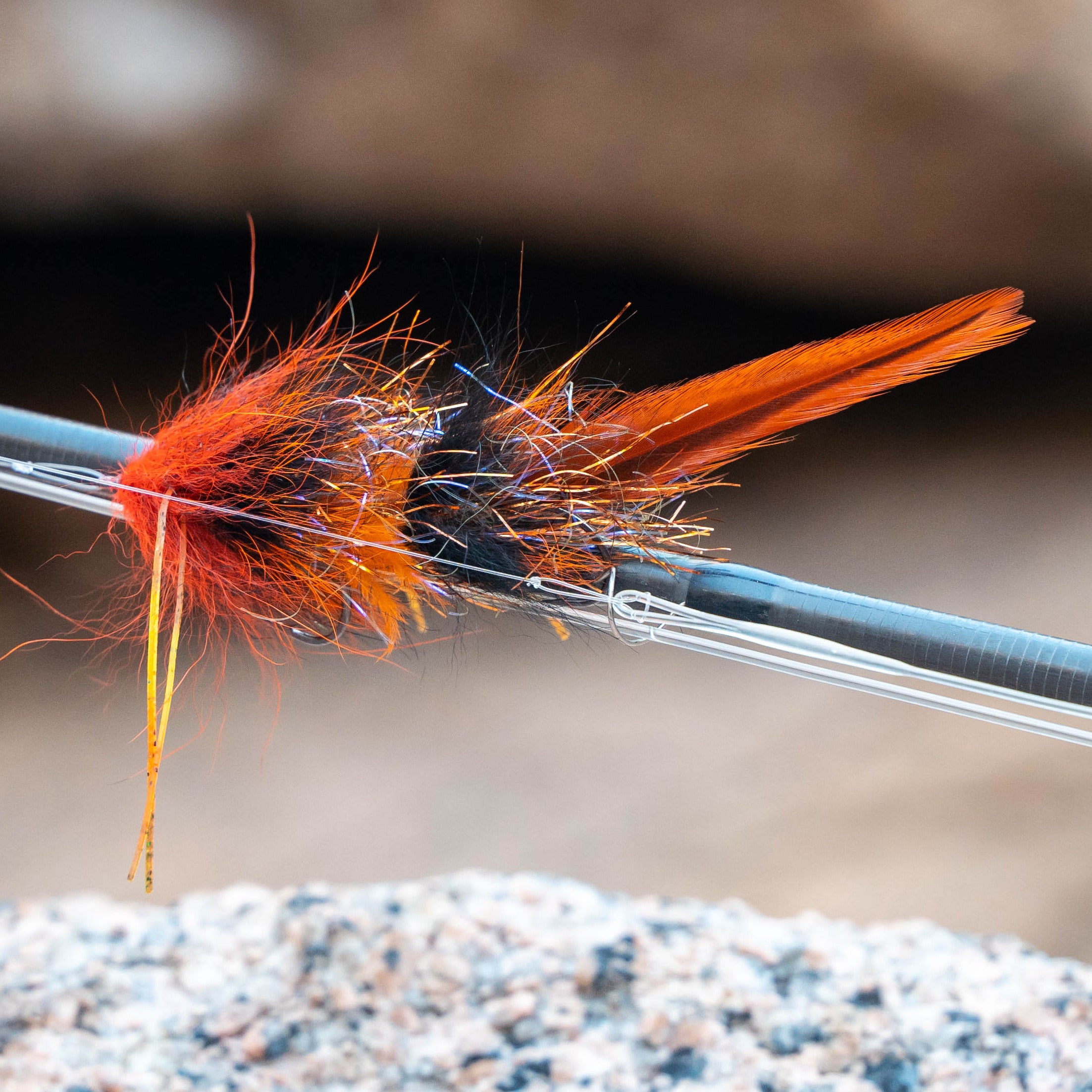 Close-up of a fly fishing fly on a hook against a natural background